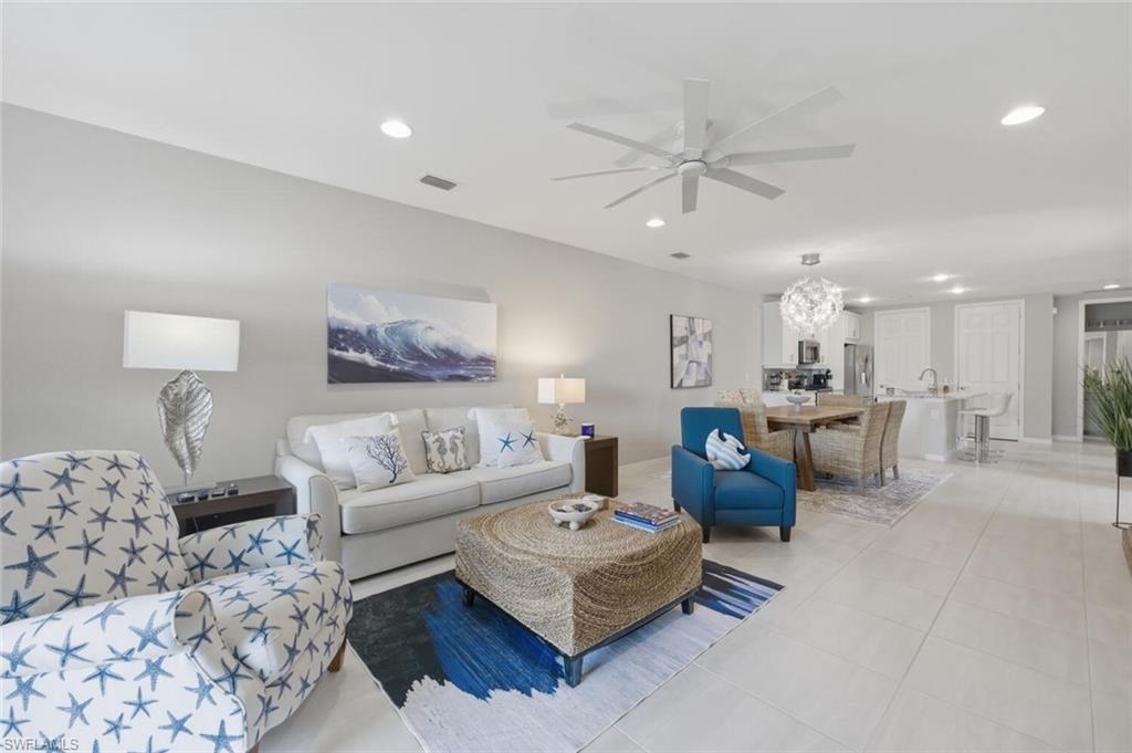 14827 Edgewater Circle Naples, FL 34114 - Photo 7 of 49 a living room with furniture and a view of kitchen