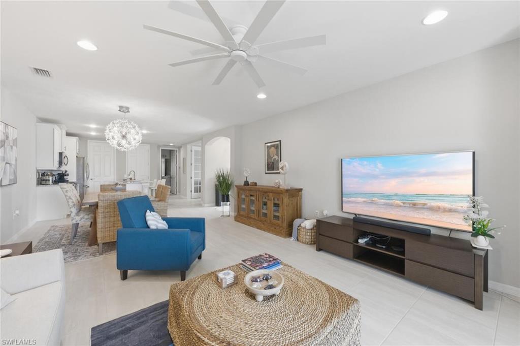 14827 Edgewater Circle Naples, FL 34114 - Photo 8 of 49 a living room with furniture and a flat screen tv