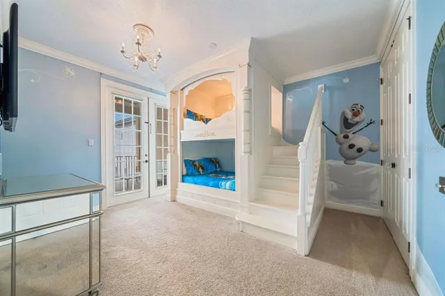 a view of a hallway with wooden floor and livingroom with fireplace