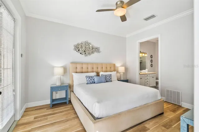 a bedroom with a large bed and a chandelier