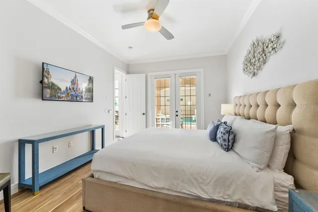 a spacious bedroom with a bed and a painting on the wall
