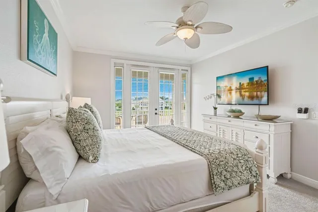 a bedroom with a large bed and a flat tv screen