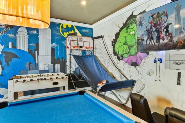 a bedroom with a bed and a baby home on a dresser