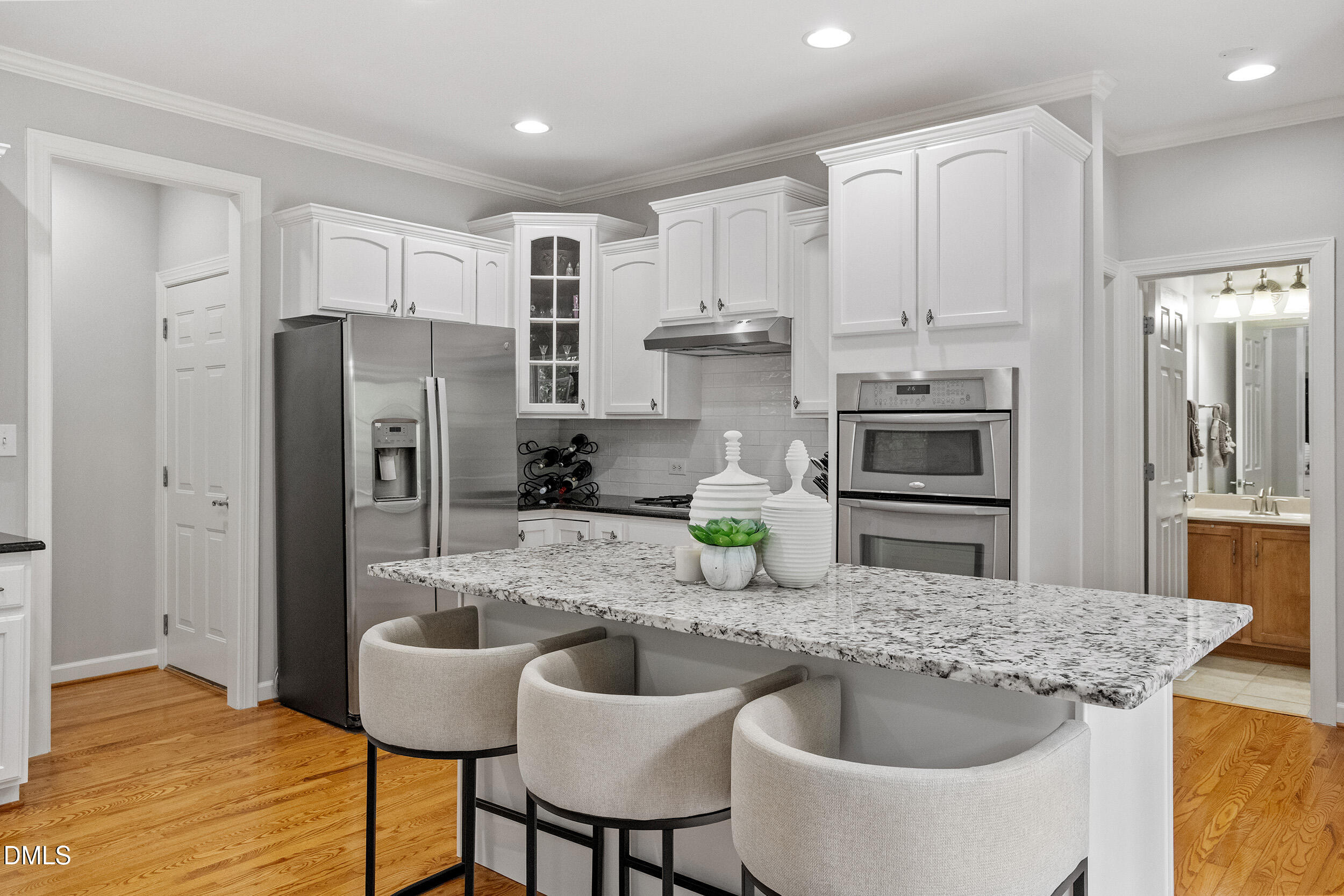 1019 Bianco Drive Raleigh, NC 27607 - Photo 10 of 29 a kitchen with refrigerator a sink and chairs