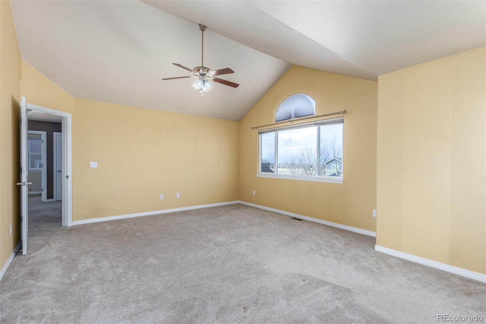 6654 12th Street Frederick, CO 80530 - Photo 19 of 50 an empty room with windows and fan