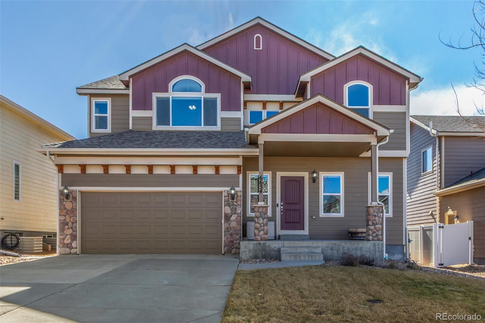 6654 12th Street Frederick, CO 80530 - Photo 2 of 50 a front view of a house with yard