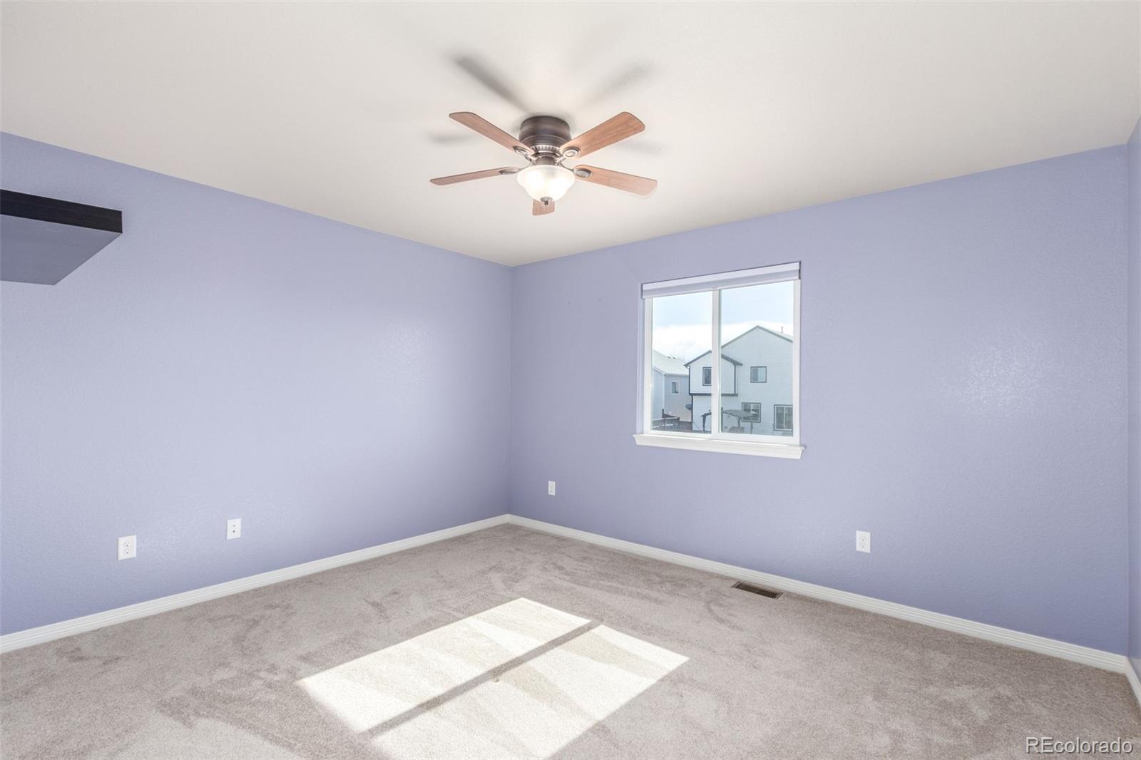 6654 12th Street Frederick, CO 80530 - Photo 25 of 50 an empty room with windows and fan