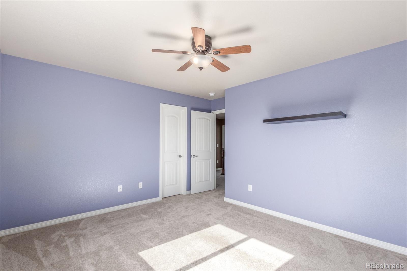 6654 12th Street Frederick, CO 80530 - Photo 26 of 50 a view of a room with a ceiling fan and window