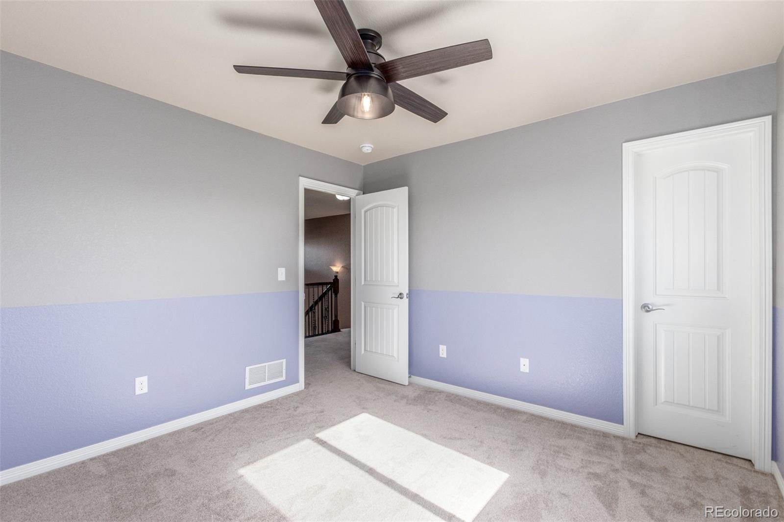 6654 12th Street Frederick, CO 80530 - Photo 30 of 50 an empty room with closet and fan