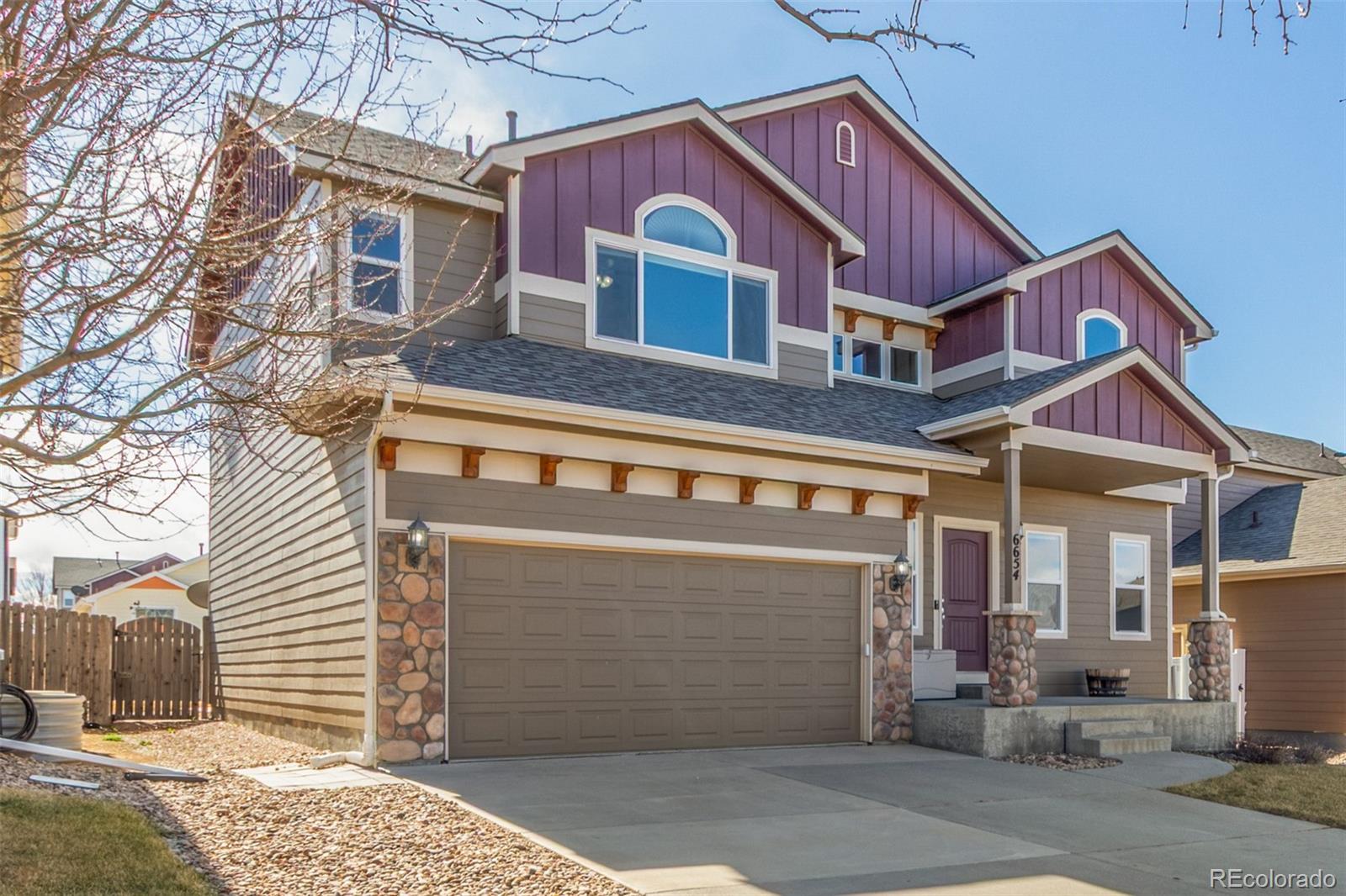 6654 12th Street Frederick, CO 80530 - Photo 3 of 50 a front view of a house with a garage