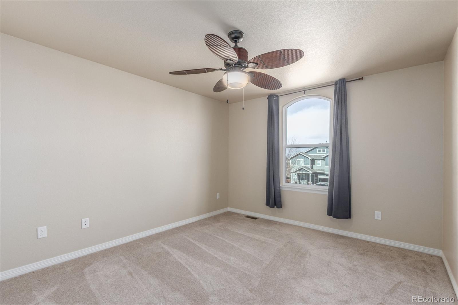 6654 12th Street Frederick, CO 80530 - Photo 31 of 50 an empty room with windows and ceiling fan