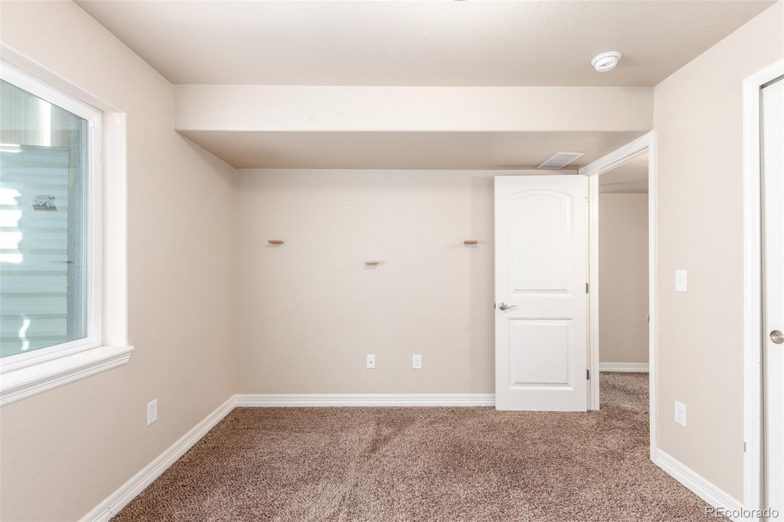 6654 12th Street Frederick, CO 80530 - Photo 42 of 50 an empty room with windows