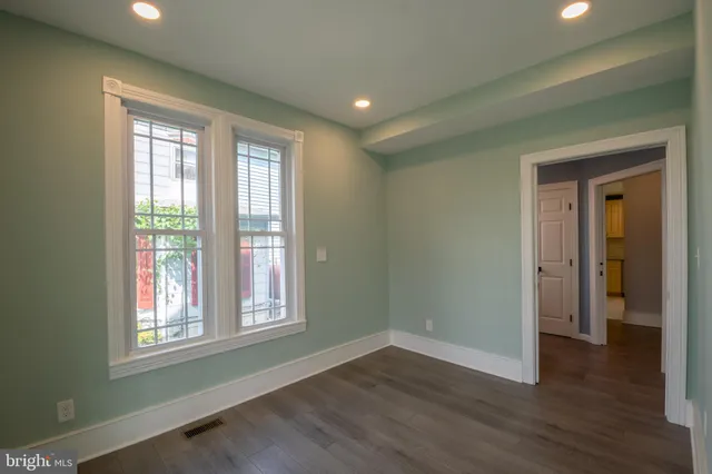 a view of wooden floor and windows in a room
