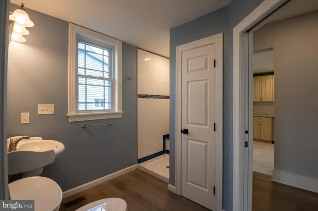 a view of hallway with stairs and wooden floor