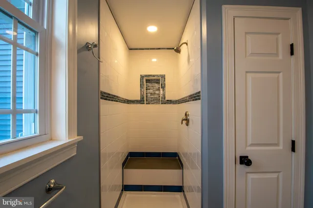 a bathroom with a granite countertop shower and a toilet