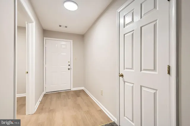 a view of a livingroom with wooden floor and staircase