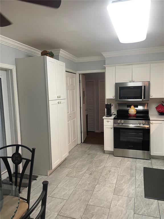 575 Tiberon Cove Road Longwood, FL 32750 - Photo 19 of 56 a kitchen with stainless steel appliances granite countertop a refrigerator and a stove top oven