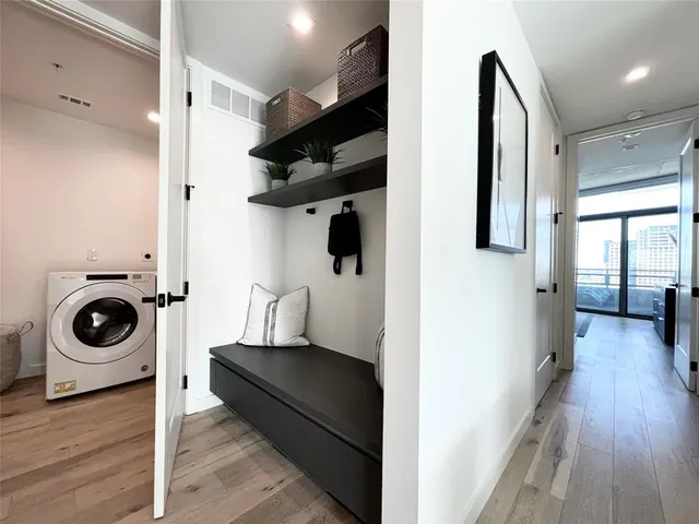 a view of a hallway with washer and dryer