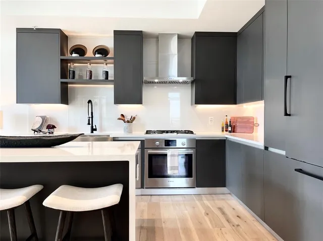 a kitchen with stainless steel appliances a stove and a refrigerator