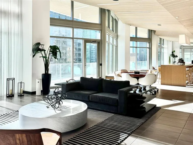 a living room with couches a table and chairs