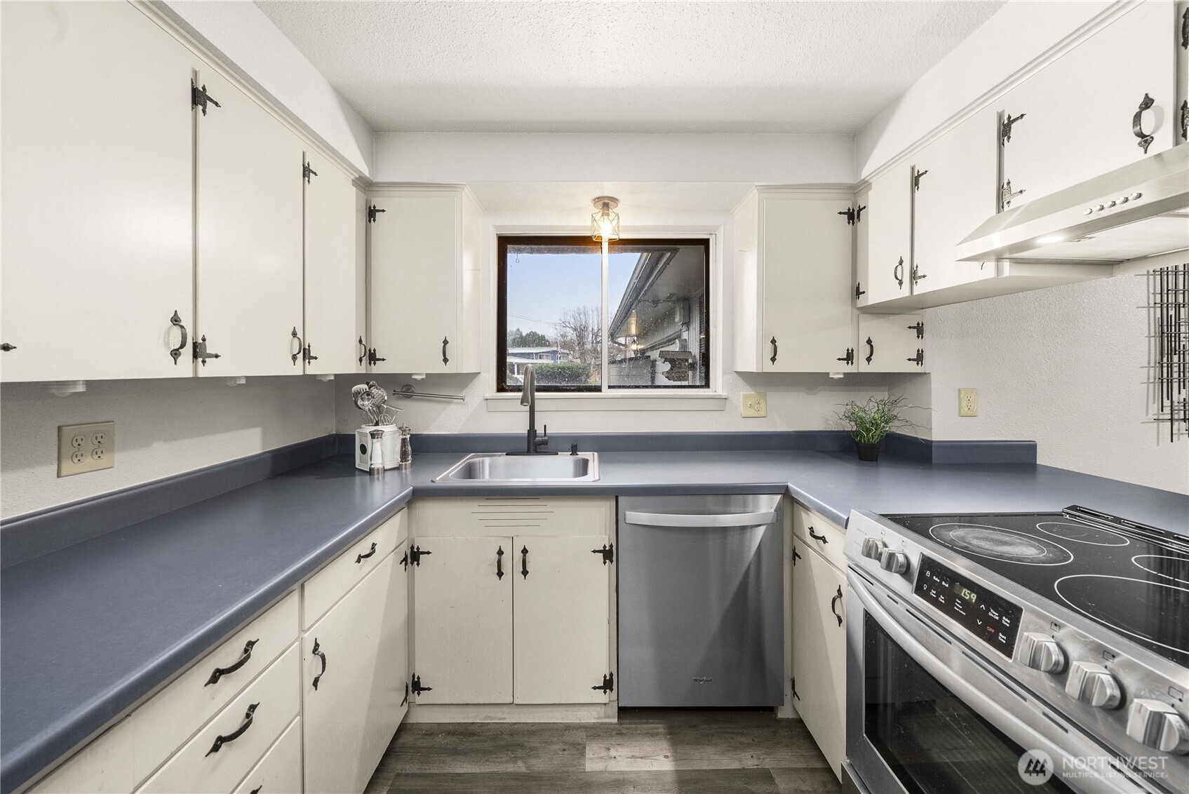152 Christina Drive Sumner, WA 98390 - Photo 14 of 26 a kitchen with stainless steel appliances a sink stove and cabinets