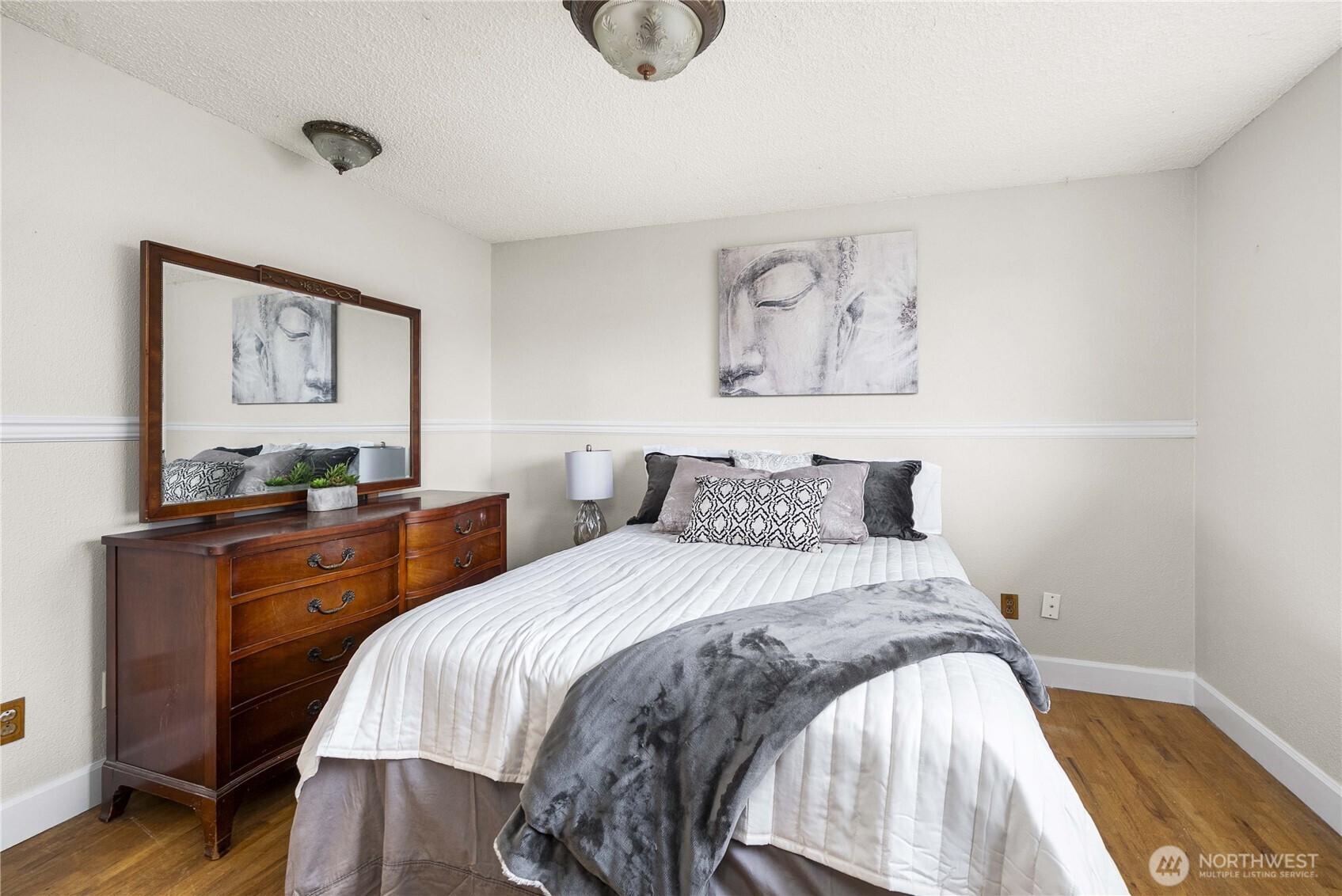 152 Christina Drive Sumner, WA 98390 - Photo 17 of 26 a bedroom with a bed and painting on the wall