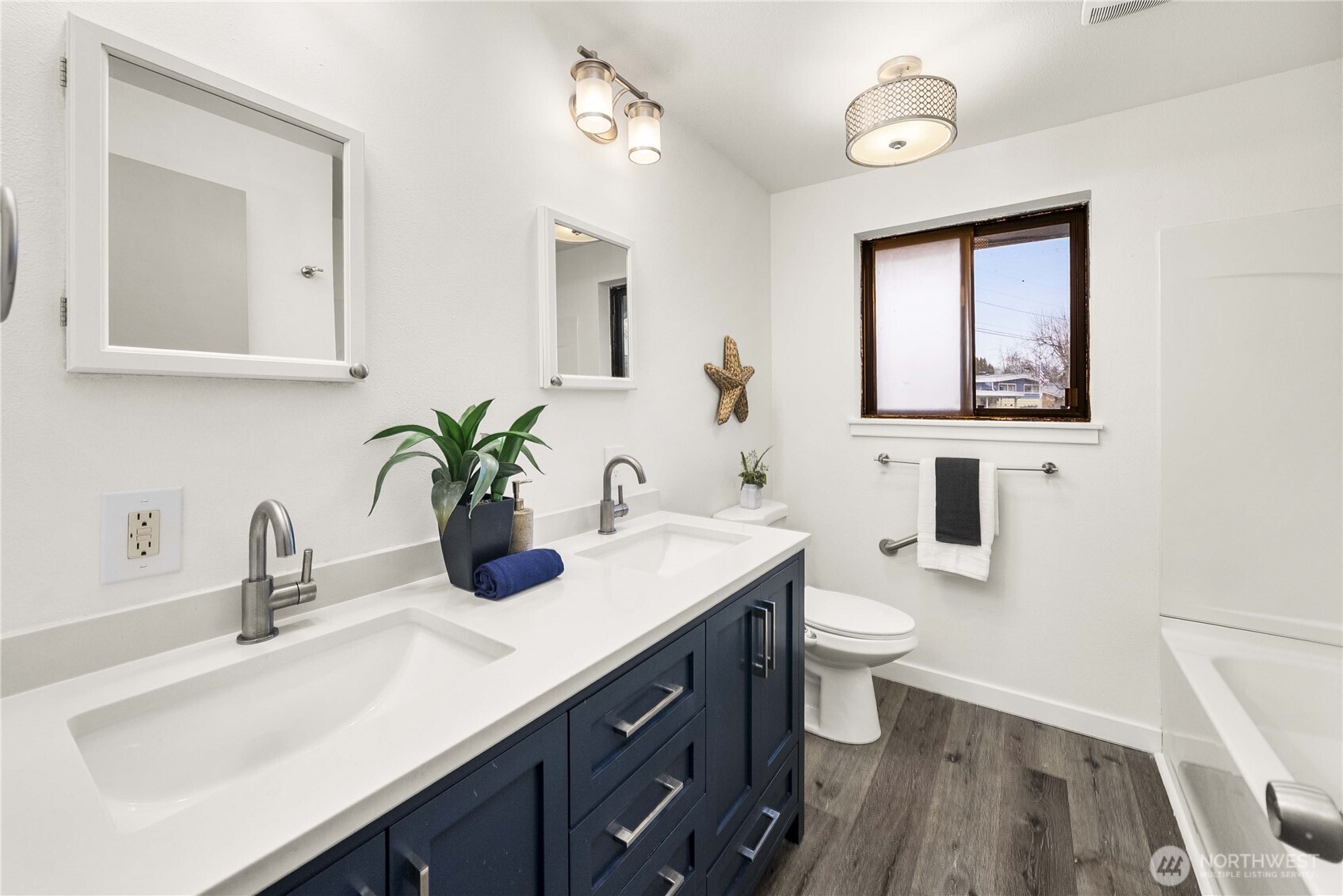152 Christina Drive Sumner, WA 98390 - Photo 20 of 26 a bathroom with a sink a toilet and mirror
