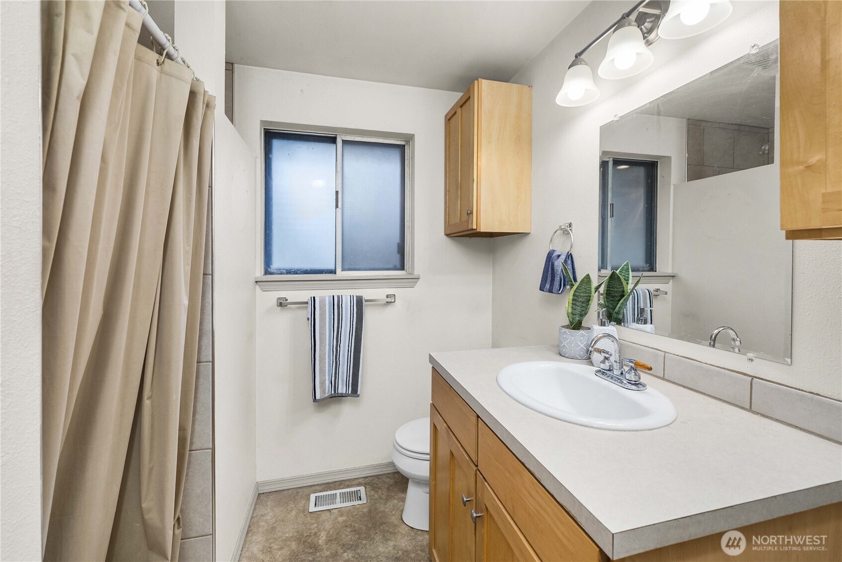 152 Christina Drive Sumner, WA 98390 - Photo 22 of 26 a bathroom with a sink a toilet and mirror