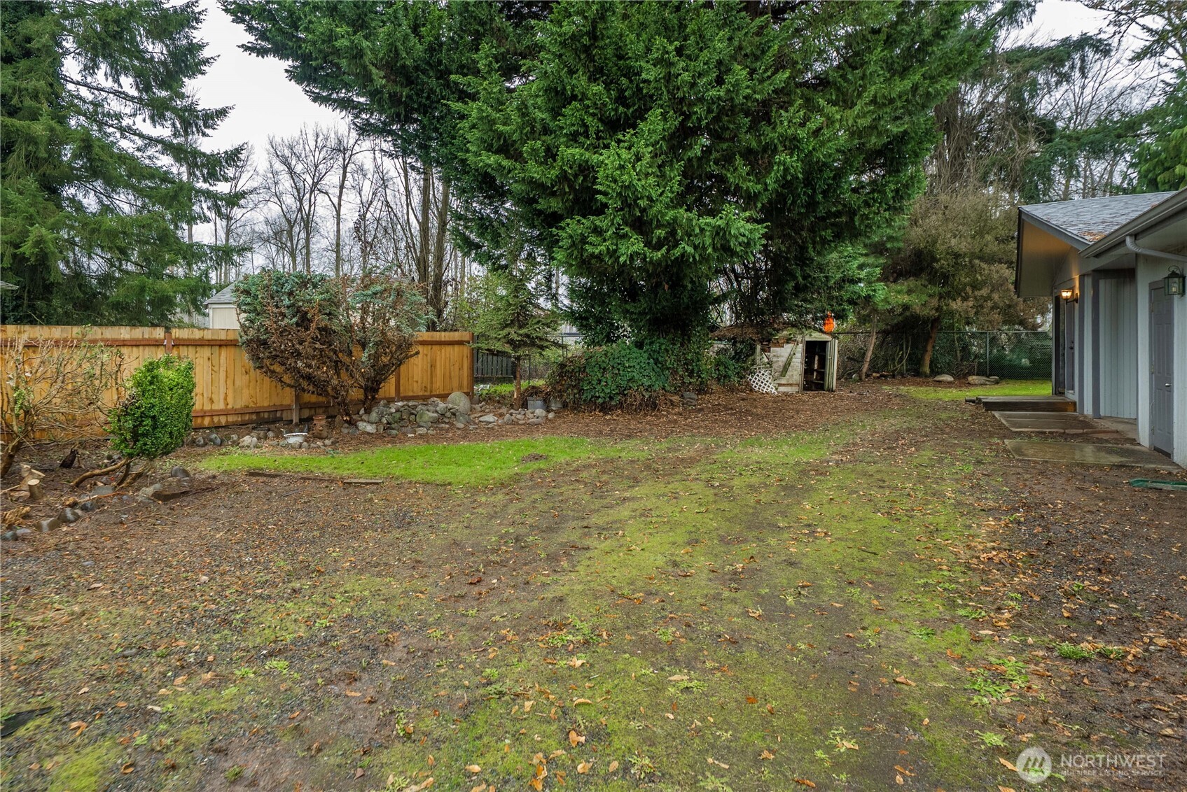 152 Christina Drive Sumner, WA 98390 - Photo 24 of 26 a backyard of a house with childrens swings and slides