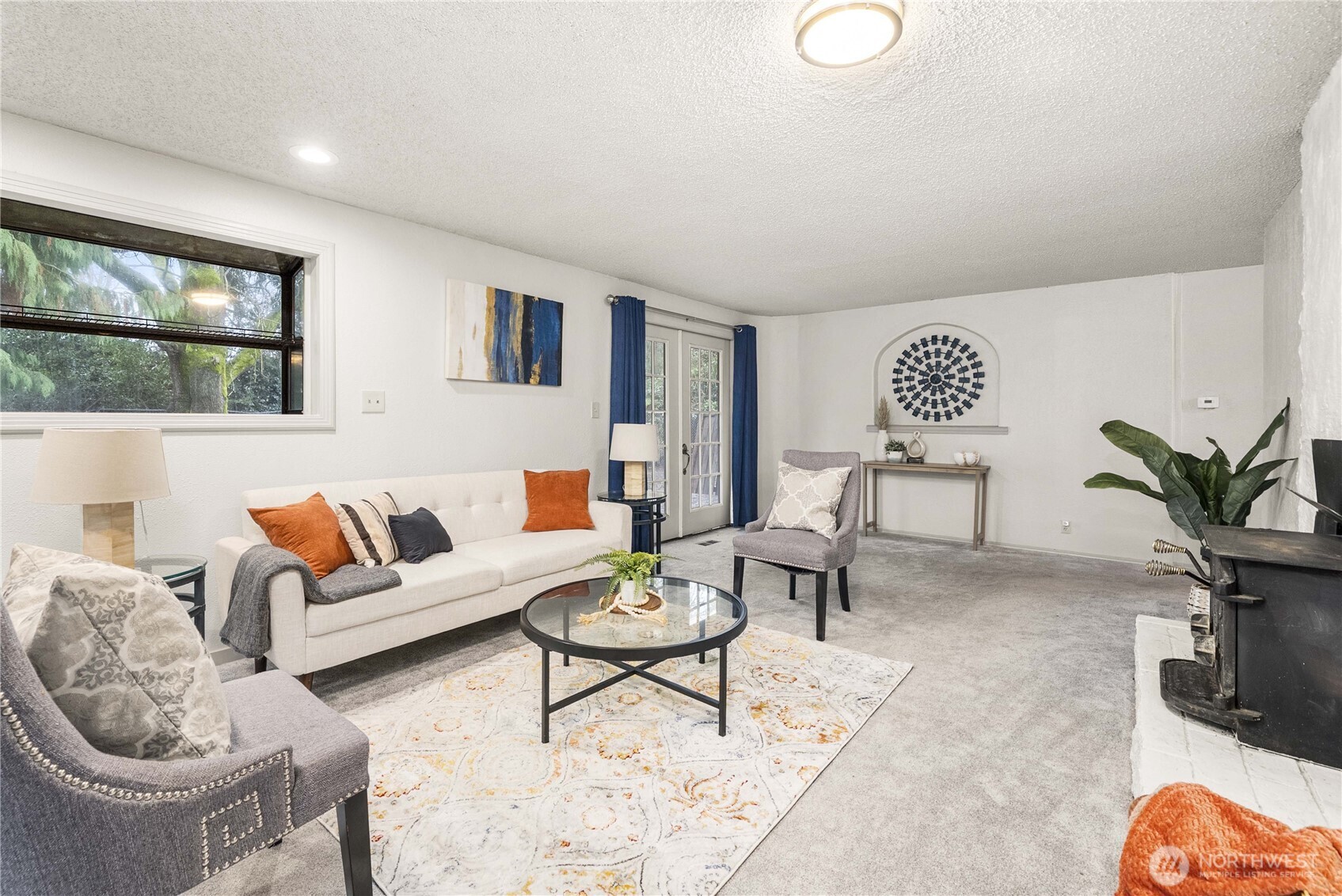 152 Christina Drive Sumner, WA 98390 - Photo 5 of 26 a living room with furniture a rug and a wall painting
