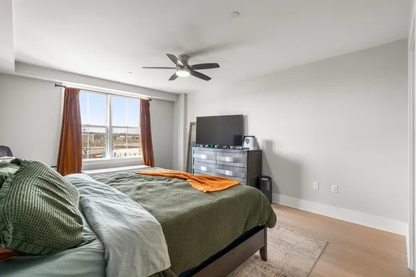 a bedroom with a bed and a tv