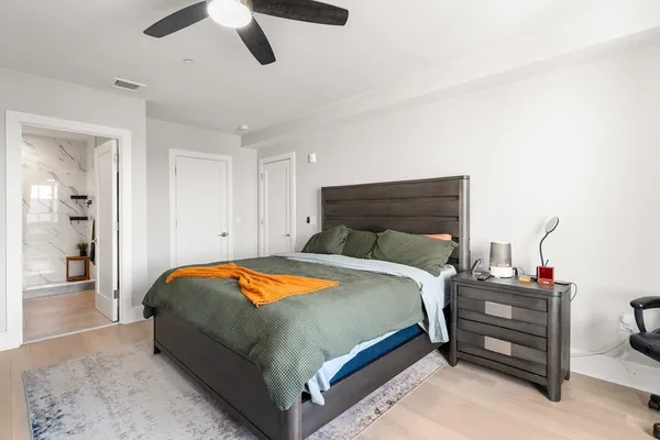 a bedroom with a bed and a chandelier