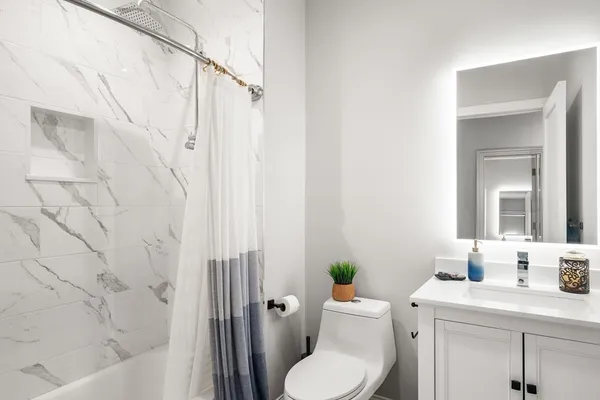 a bathroom with a toilet sink and shower
