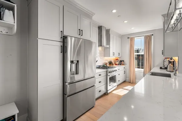 a kitchen with stainless steel appliances a refrigerator sink and cabinets