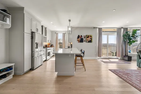 a living room with furniture and a kitchen