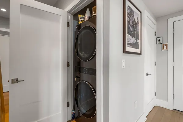 a view of a hallway with washer and dryer
