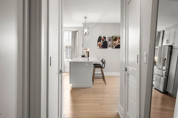 a view of a hallway with wooden floor windows and a livingroom view