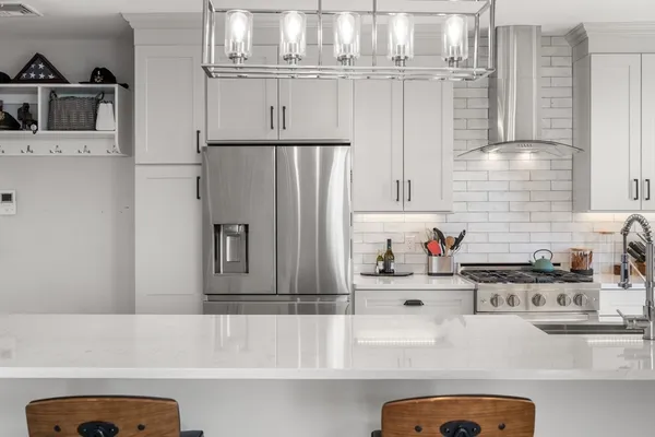 a kitchen with stainless steel appliances a white refrigerator and a sink