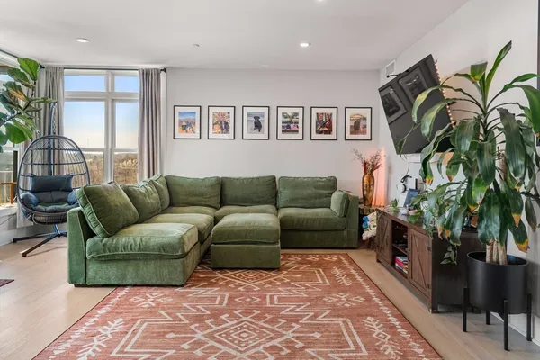a living room with furniture and a potted plant