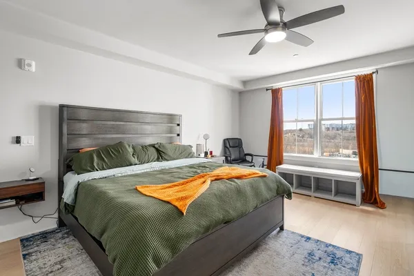 a bedroom with a bed and a window