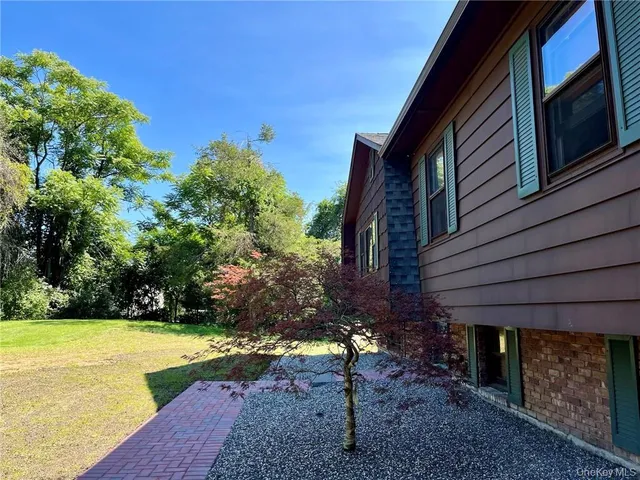 a view of a house with backyard porch and sitting area