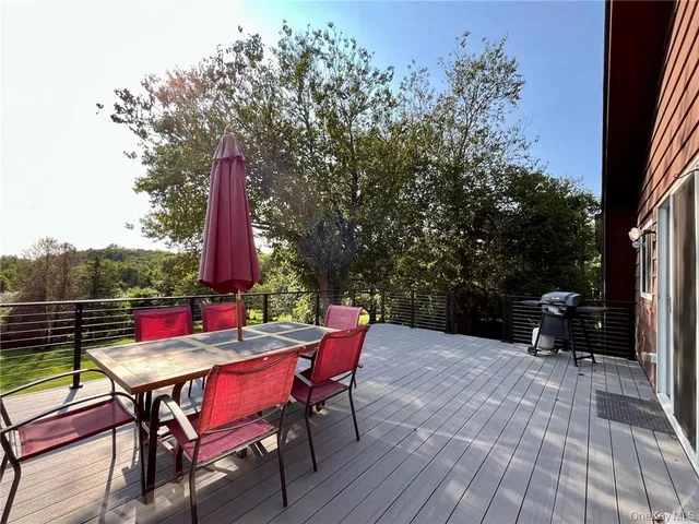an outdoor sitting area with furniture and wooden floor