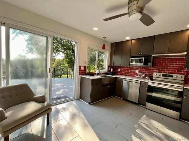 a kitchen with stainless steel appliances kitchen island granite countertop a sink and cabinets