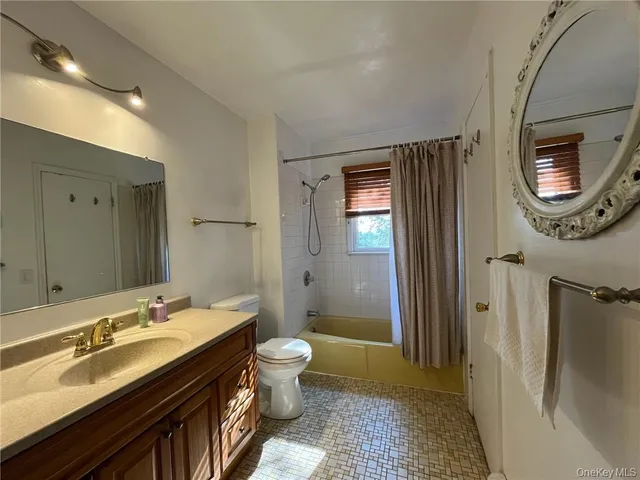 a spacious bathroom with a double vanity sink a mirror and a shower