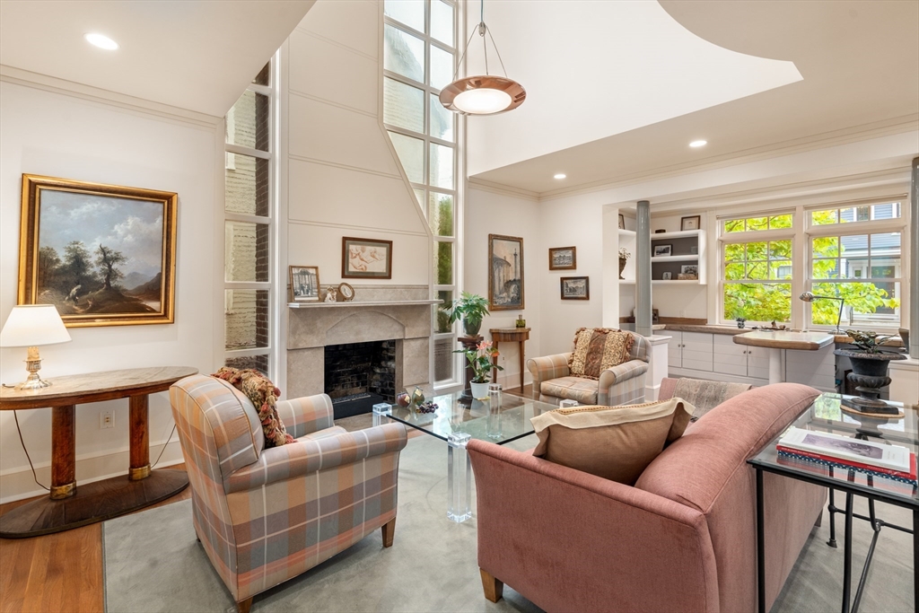 26 Healey Street Cambridge, MA 02138 - Photo 6 of 24 a living room with furniture a chandelier and a fireplace