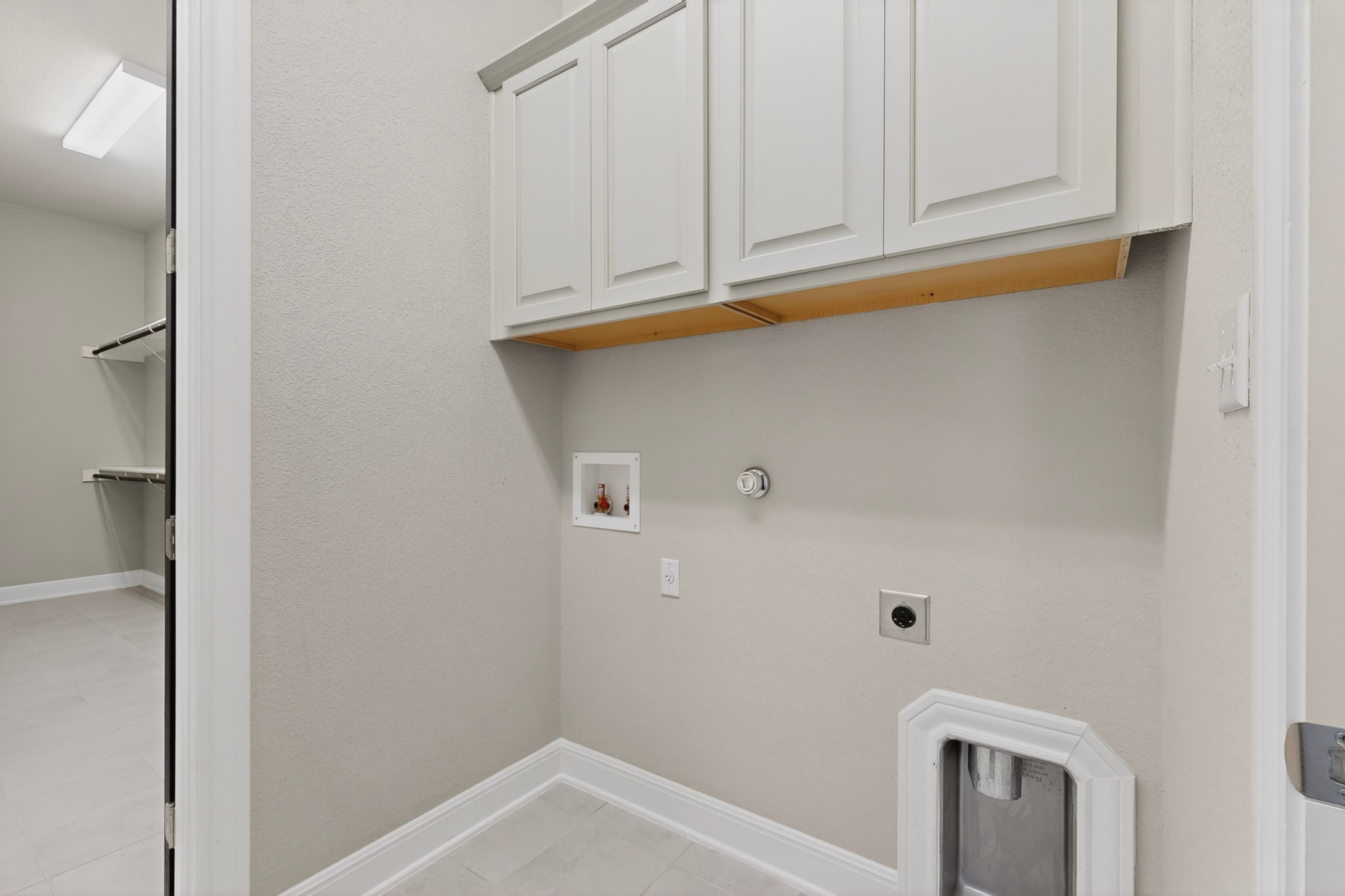 2617 Milan Meadows Drive Leander, TX 78641 - Photo 17 of 40 Functional laundry space featuring ample overhead cabinetry and necessary hookups for convenience.