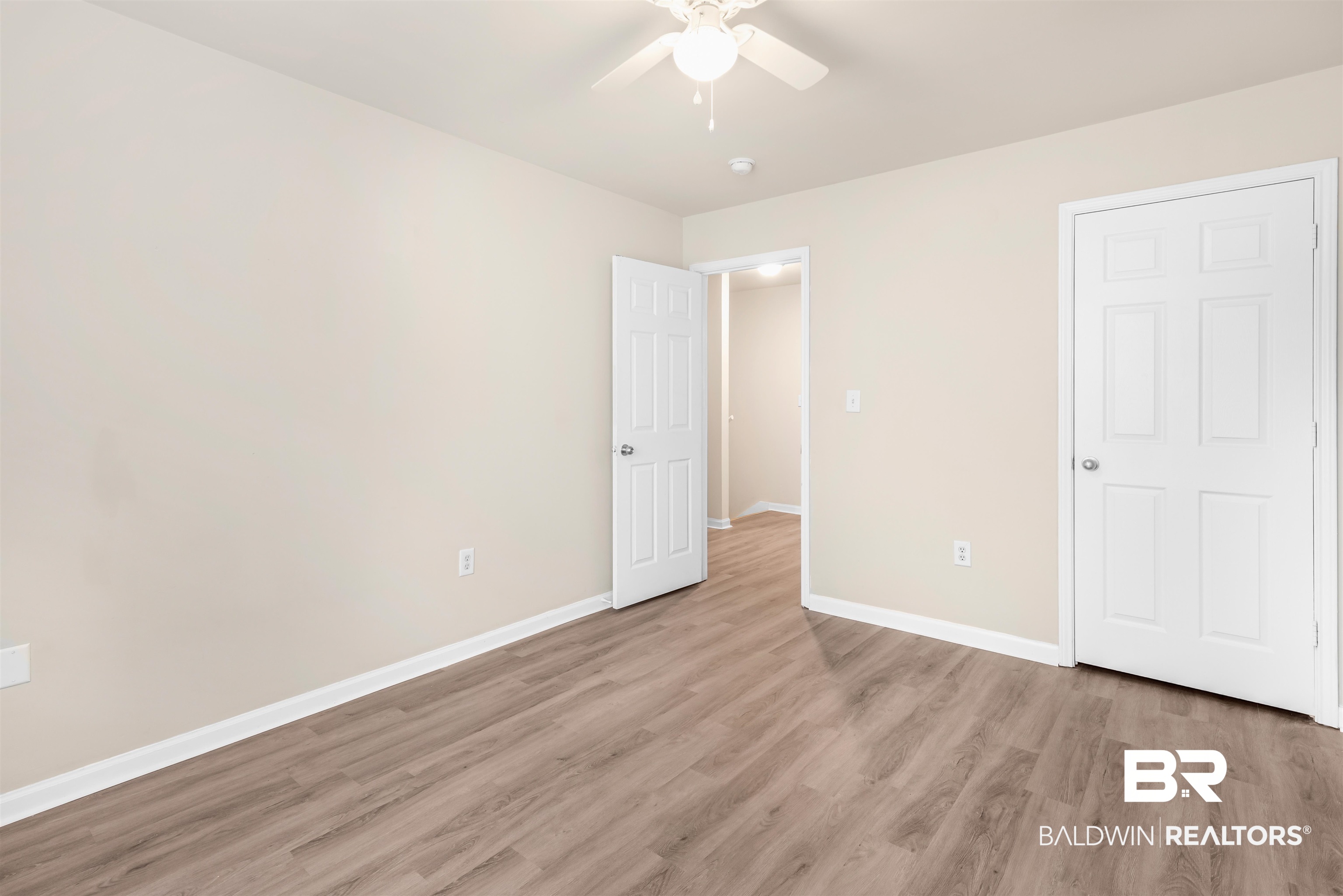 1517 Regency Road, Unit 85 Gulf Shores, AL 36542 - Photo 9 of 32 Unfurnished bedroom with hardwood / wood-style flooring and ceiling fan