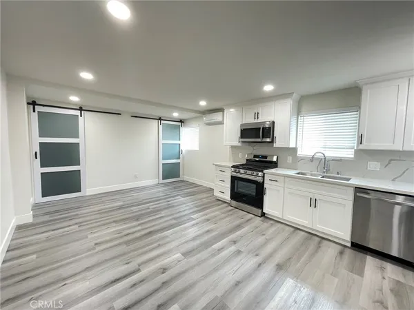 a kitchen with granite countertop a stove top oven and sink