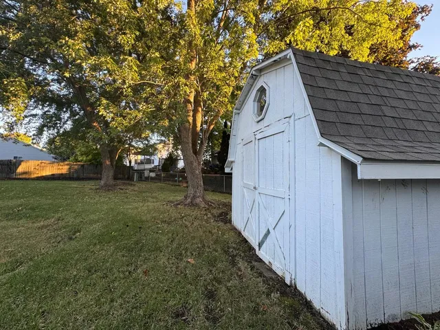 a view of backyard of house with trees