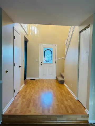 a view of a big room with wooden floor and cabinet